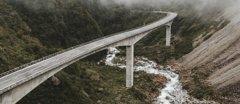 A bridge over a raging river is a metaphor for overcoming hurdles during a brand refresh.